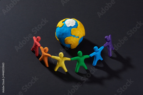 Multicultural people around Earth. Justice and no racism concept. Gender and racial equality. DIY. Children's crafts from colored plasticine. Group of people around the world.