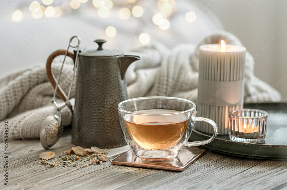 Cozy composition with a cup of tea, a teapot and candles. Cozy composition with a cup of tea, a teapot and candles.