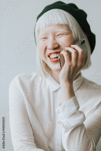 Cool and stylish albino girl talking on her phone photo
