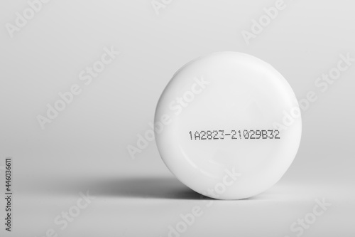 Lot number and manufacturing date on the bottom of the product with isolated white background.