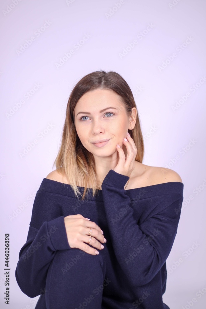 young thin girl in a knitted suit on a light background. Tenderness, femininity. young thin girl in a knitted suit on a light background. Tenderness, femininity.