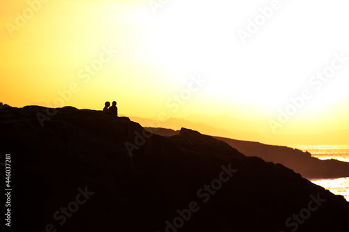 Couple enjoying the sunset at the coast