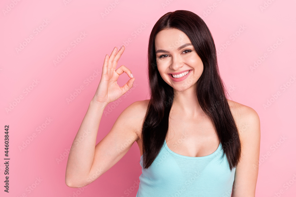 Photo of young attractive girl happy positive smile show okay alright sign promo deal isolated over pastel color background Photo of young attractive girl happy positive smile show okay alright sign promo deal isolated over pastel color background
