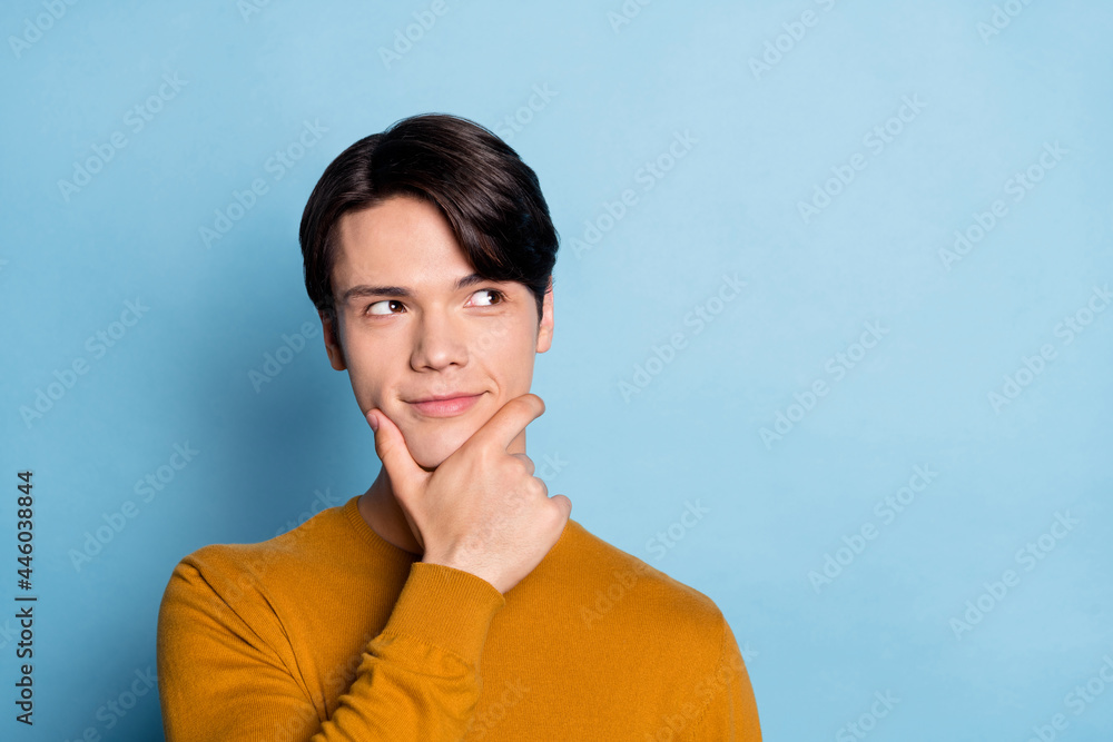 Obraz premium Photo of think brunet young guy look empty space wear brown sweater isolated on blue color background