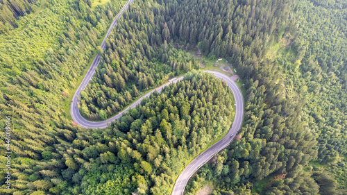 The road passing in the forest along the mountain pass