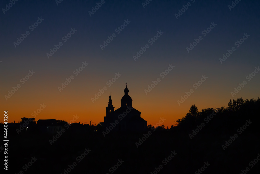 Silhouette of the Church of Elijah the Prophet at sunset in Suzdal. Nature background sunset on the river.