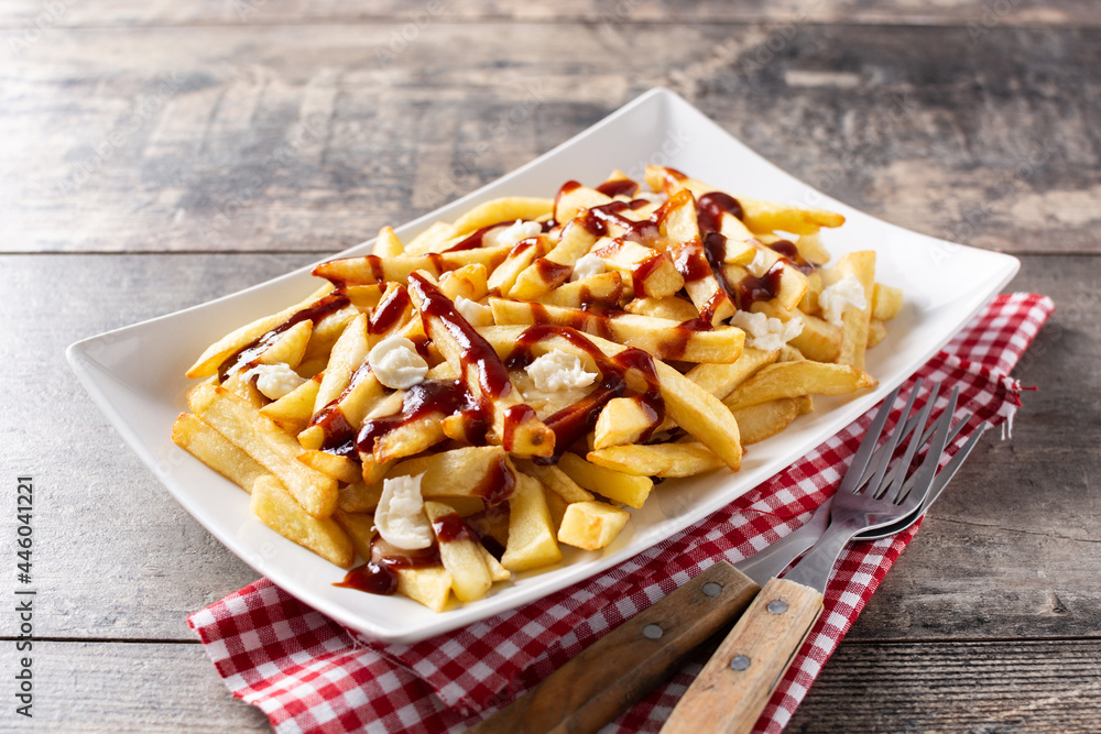 Fototapeta premium Traditional Canadian Poutine on wooden table. Top view. 