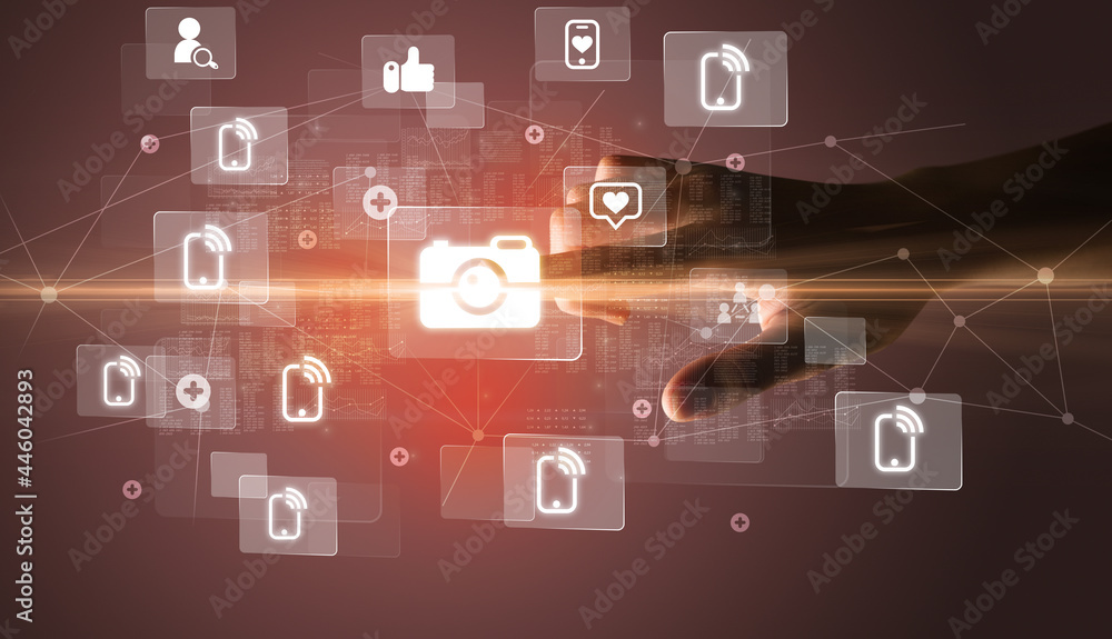 Hand pressing social media multimedia application screen with media icons on futuristic concept Hand pressing social media multimedia application screen with media icons on futuristic concept