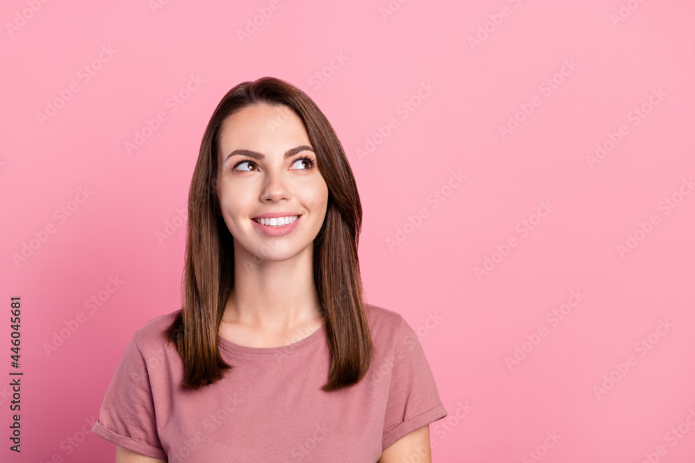 Photo of nice brunette millennial lady look empty space wear t-shirt isolated on pink color background Photo of nice brunette millennial lady look empty space wear t-shirt isolated on pink color background