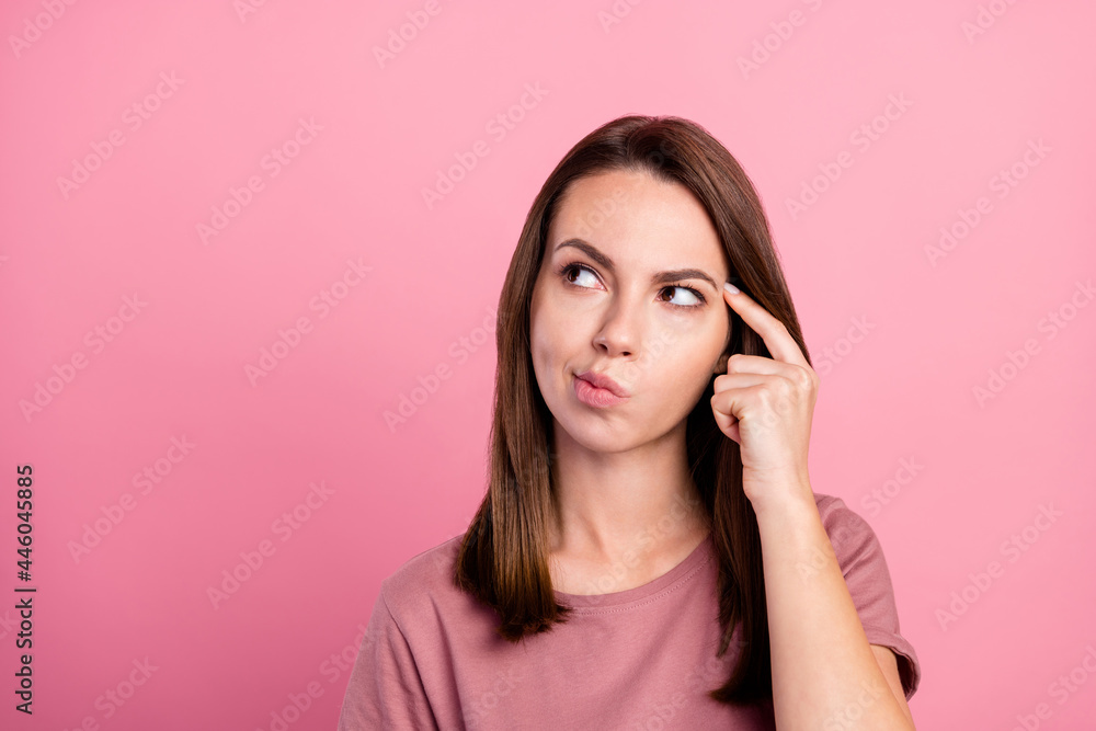 Photo of charming thoughtful young lady wear casual outfit finger temple looking empty space isolated pink color background Photo of charming thoughtful young lady wear casual outfit finger temple looking empty space isolated pink color background