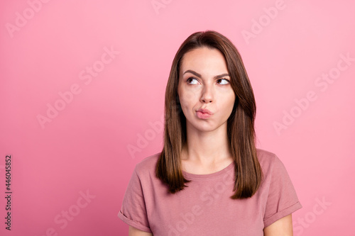 Photo of young attractive woman think hmm deep idea look empty space isolated over pink color background