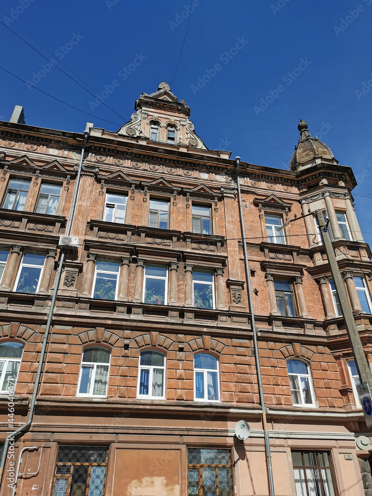 The facade of an old residential building on one of the streets of Vyborg on a sunny summer day.