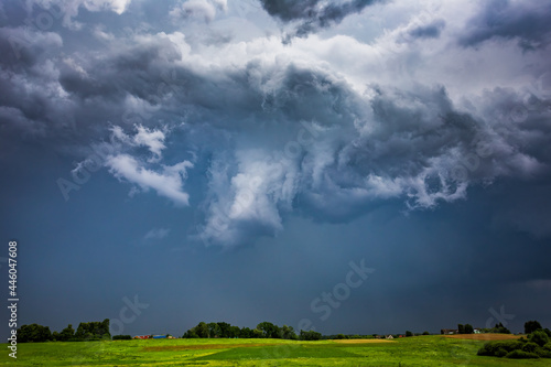 Extreme thunderstorm supercell with white hail core, hail falling on a village