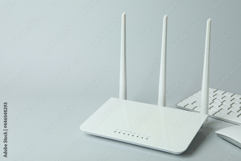 Workplace with Wi - fi router on gray background Workplace with Wi - fi router on gray background