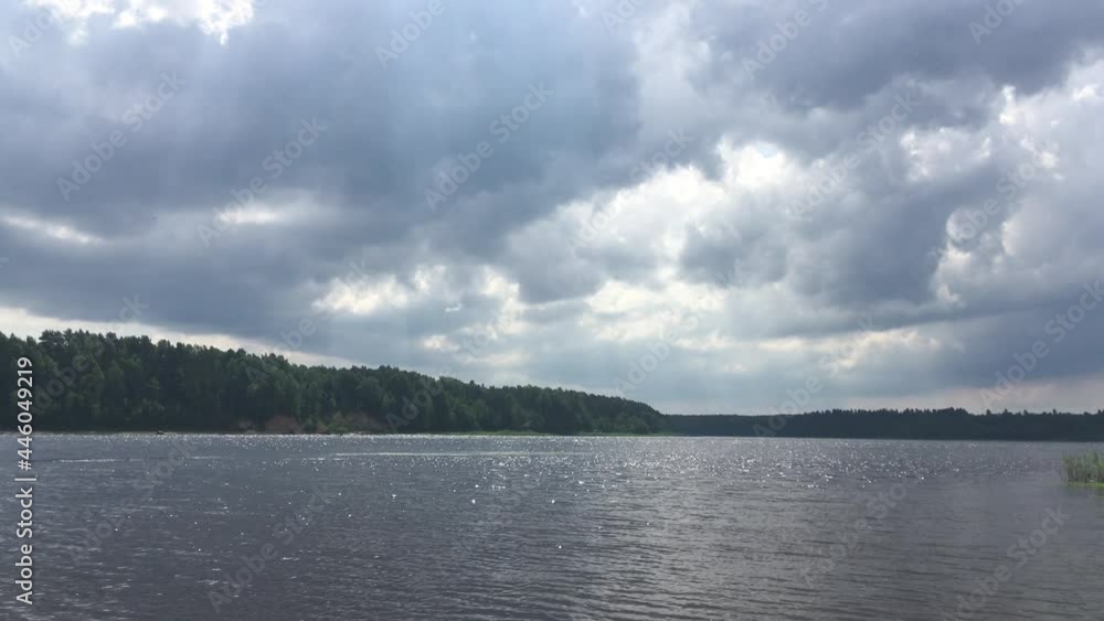 Beautiful summer landscape - river, forest, cloudy sky and sunbeams. Nature background Beautiful summer landscape - river, forest, cloudy sky and sunbeams. Nature background