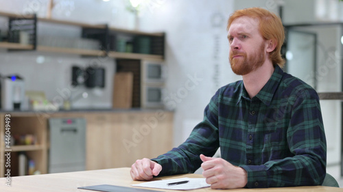 Redhead Man Feeling Disappointed on Documents 