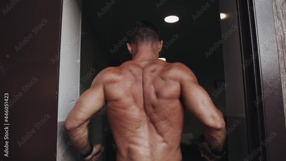 The bodybuilder shows the result of his training and demonstrates a pose for the broadest muscles of the back The bodybuilder shows the result of his training and demonstrates a pose for the broadest muscles of the back