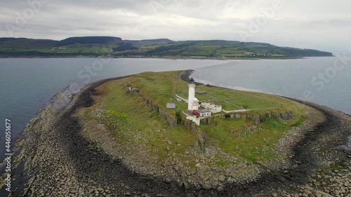 The Island of Pladda off the South Coast of Arran in Scotland with a Lighthouse photo