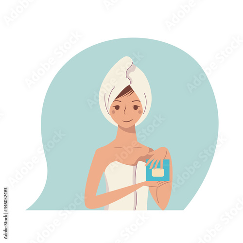 Nice girl in a towel made a hair mask. Self-care procedure.