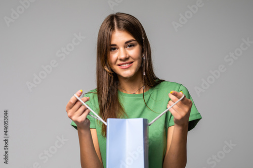 Beautiful woman with a shopping bag. Isolated on white.