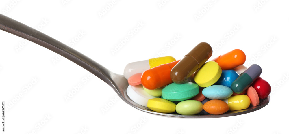 Different colorful pills in spoon isolated on white Different colorful pills in spoon isolated on white