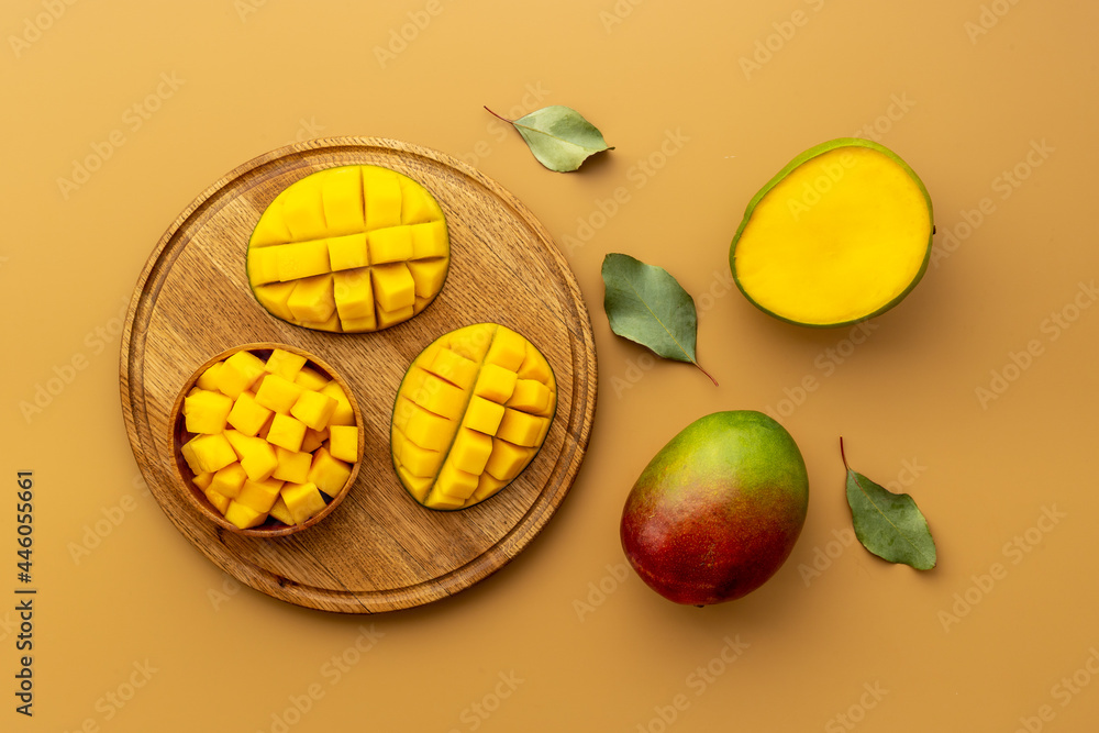 Mango fruit slices and cubes in wooden bowl