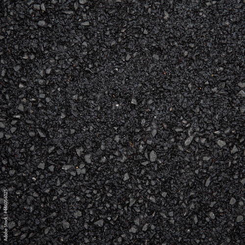 Close - up of rough black asphalt surface texture and background seamless