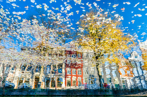 Colorful reflection of the buildings along the canal in Amsterdam in the autumn