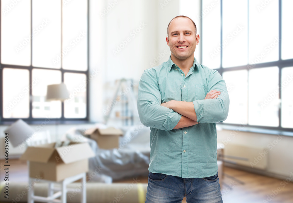 moving, real estate and people concept - smiling man with crossed arms over new home background moving, real estate and people concept - smiling man with crossed arms over new home background