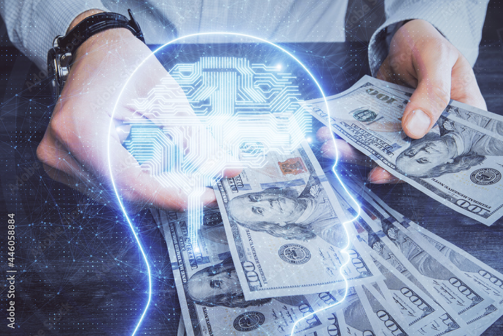 Multi exposure of brain drawing hologram and us dollars bills and man hands. Ai invest concept Multi exposure of brain drawing hologram and us dollars bills and man hands. Ai invest concept