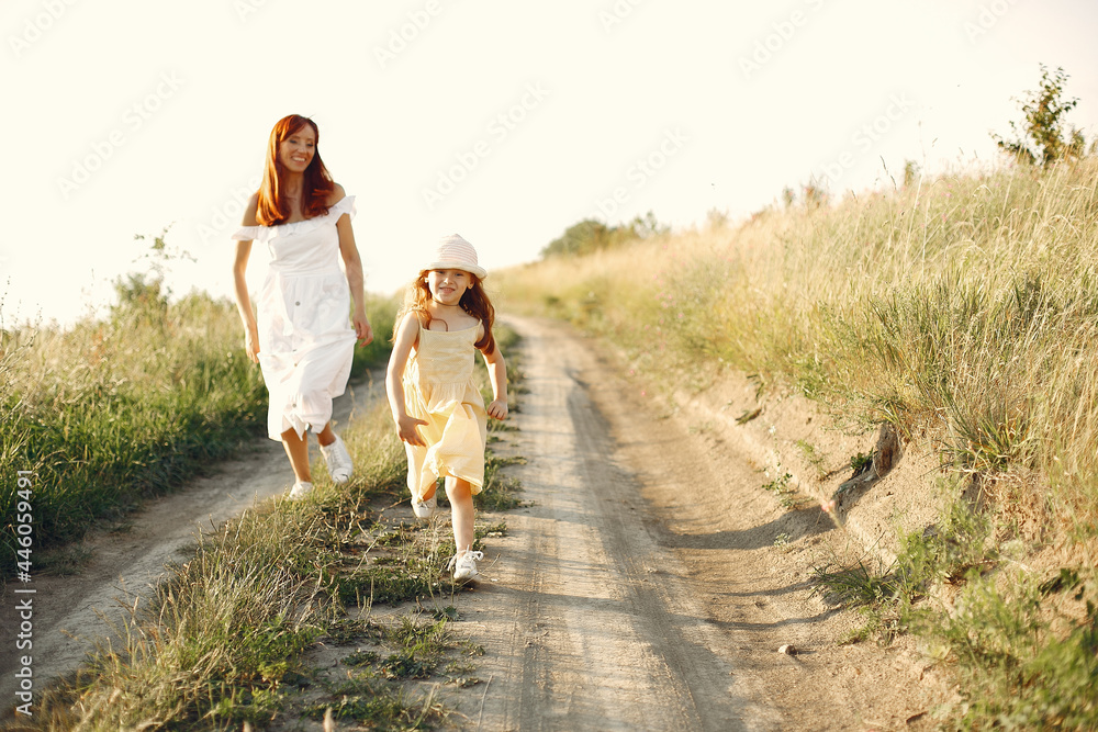 Mother with daughter playing in a summer field Mother with daughter playing in a summer field
