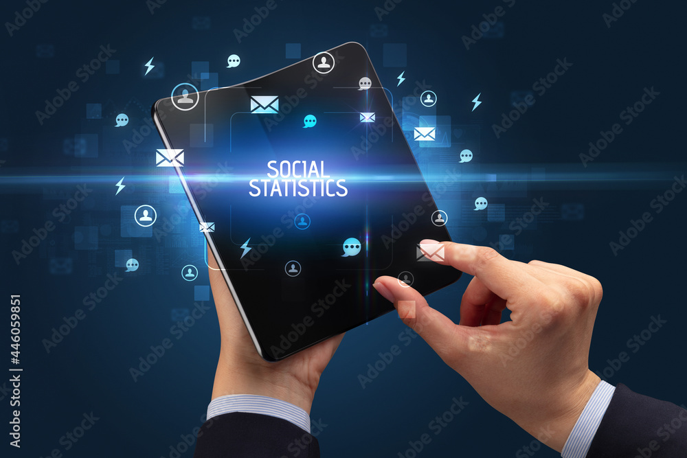 Obraz premium Businessman holding a foldable smartphone, social media concept