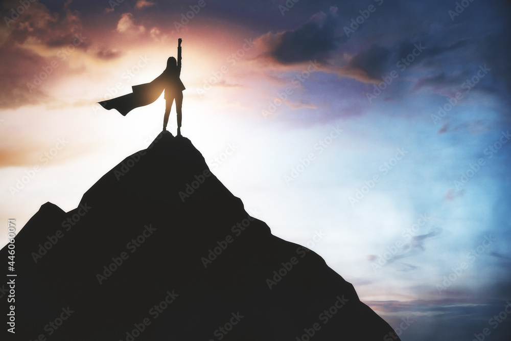 Winner and hero concept with superwoman in dark coat on top of the rock at amazing sky view background. - obrazy, fototapety, plakaty 