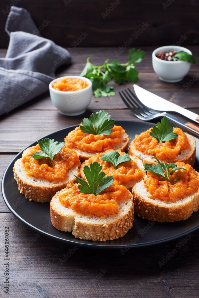 Sandwiches with bread zucchini caviar tomatoes onions. Homemade vegetarian food. Canned stewed vegetable. wooden background Sandwiches with bread zucchini caviar tomatoes onions. Homemade vegetarian food. Canned stewed vegetable. wooden background