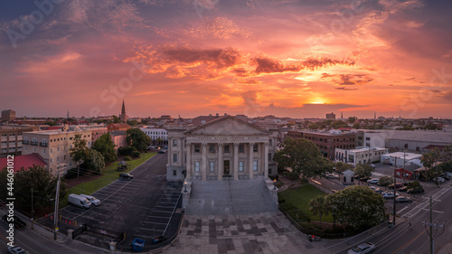 Sunset aerial view of old custom house with classical Greek style columns in the historic center of Charleston South Carolina orange, red dramatic sky background