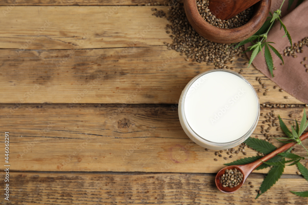 Flat lay composition with fresh hemp milk on wooden table. Space for text Flat lay composition with fresh hemp milk on wooden table. Space for text