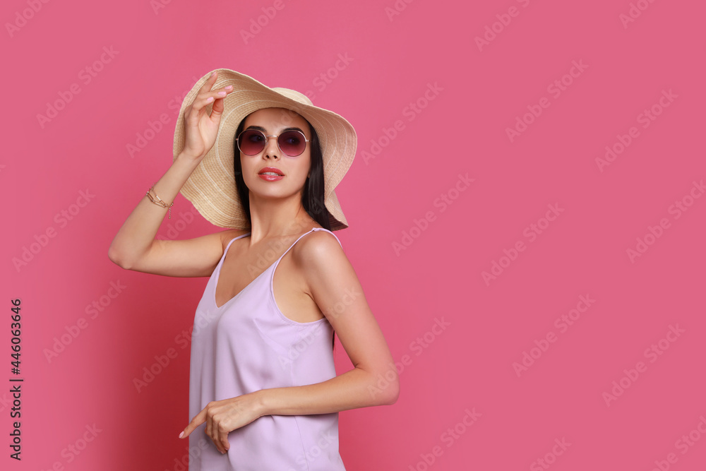 Beautiful young woman with straw hat and stylish sunglasses on pink background. Space for text Beautiful young woman with straw hat and stylish sunglasses on pink background. Space for text