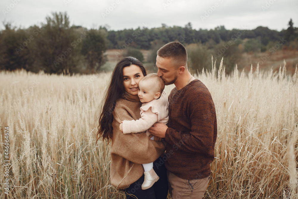Cute and stylish family playing in a autumn field Cute and stylish family playing in a autumn field