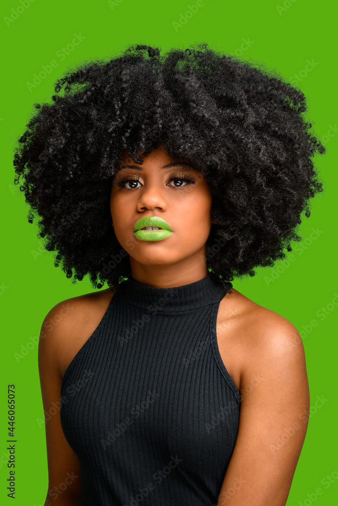 Confident black woman with afro hair style looking at camera
