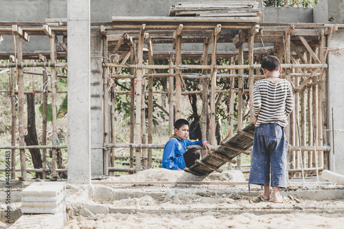 Children working on construction sites,  Poor children, poverty, Child labor, human trafficking, World Day Against Child Labour concept. © Tinnakorn