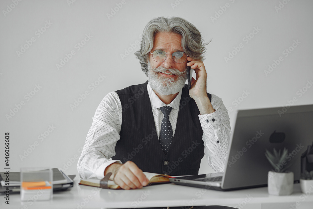 Fototapeta premium Handsome pensive mature businessman in the office