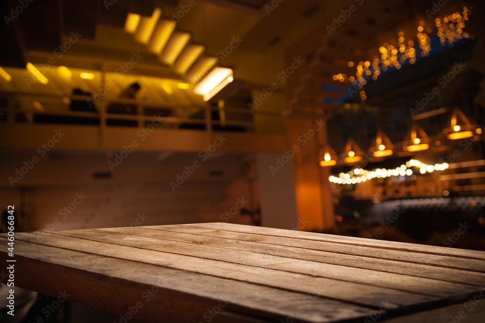 image of wooden table in front of abstract blurred background recreating lights of restaurant cafe image of wooden table in front of abstract blurred background recreating lights of restaurant cafe