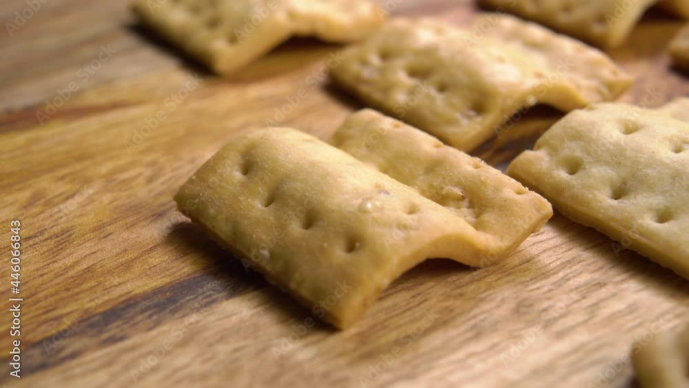 Salted crunchy wavy crackers on a wooden surface. Macro. Dolly shot. Salted crunchy wavy crackers on a wooden surface. Macro. Dolly shot.