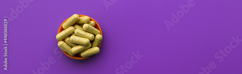 quercetin capsules on a lilac background. dietary supplement top view banner. mental wellbeing and personal health concept photo