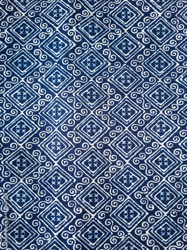 The blue fabric is dyed with a white grid pattern.vertical image