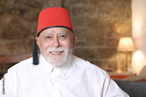 Mature middle Eastern man wearing classic fez hat photo