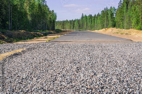 Highway construction. Asphalt paving on gravel and sand