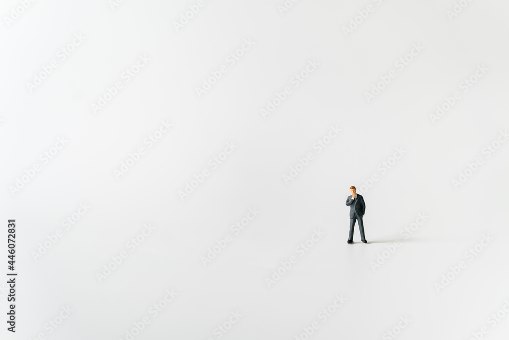 Obraz premium Miniature businessman planning thinking success deal business on white background using as commitment, insurance agreement, travel investment and partnership business development joint venture concept