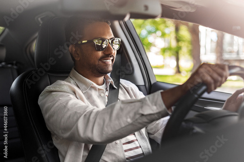 transport, vehicle and people concept - happy smiling indian man or driver in sunglasses driving car © Syda Productions