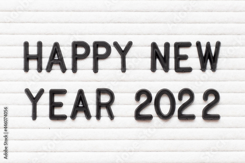 Black color letter in word happy new year 2022 on white felt board background